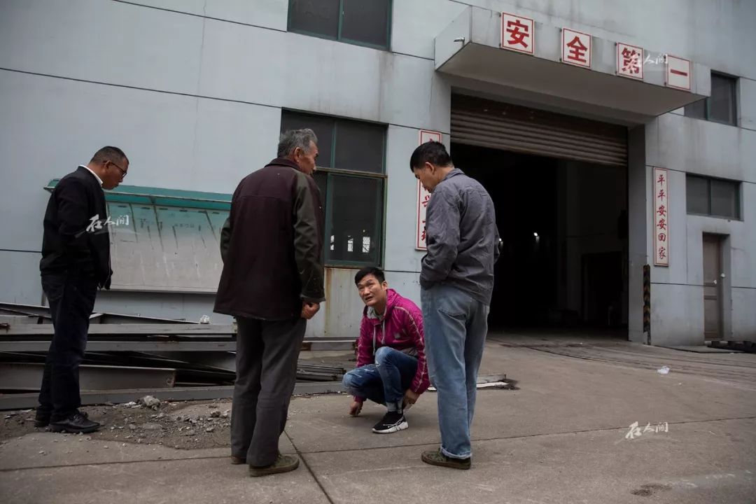 王银达和留下来的工人们讨论如何搬运剩下来的注塑机