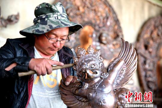 今年7月28日，文化和旅游部公布了首批全国乡村旅游重点村名单，西藏共有9个村被入选，其中拉萨市达孜区德庆镇白纳村榜上有名。图为洛桑次仁在合作社塑像。　贡桑拉姆 摄
